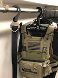 Cobra buckle belt hanging in closet with Crye SPC plate carrier hanging behind it