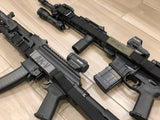Close up of Two black TOIM customizable quick adjust two point slings with laser engraved text on pull tab attached to a palmetto state armory ak-v and a palmetto state armory ar-15