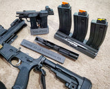 Gun stand for Sig P365 with CMMG conversion kit case and magazine holder next to it and AR-15 underneath