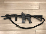 Black TOIM customizable quick adjust two point sling attached to a rifle with Attack laser engraved on the pull tab