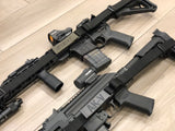 close up of Two black TOIM customizable quick adjust two point slings with laser engraved text on pull tab attached to a palmetto state armory ak-v and a palmetto state armory ar-15
