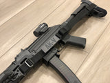 Close up of black TOIM customizable quick adjust two point sling with laser engraved text on pull tab attached to a palmetto state armory ak-v