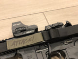 Close up of elastic keeper and custom laser engraved pull tab text on TOIM customizable quick adjust two point sling