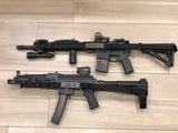 Two black TOIM customizable quick adjust two point slings with laser engraved text on pull tab attached to a palmetto state armory ak-v and a palmetto state armory ar-15