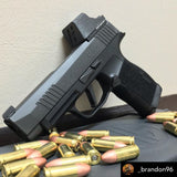 sig p365XL next to some bullets with a dust cover on holosun 507k or 407k optic