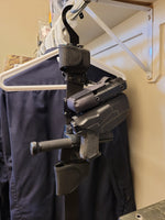 Customer image of a duty belt with handcuffs, baton, and pistol loaded on it and hanging from Hugo Industries cobra belt hanger.