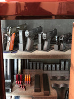 interior of safe with neatly organized magazines, guns, and snaps caps in their respective holders and stands