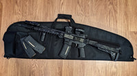 Multicam black TOIM customizable quick adjust two point sling with laser engraved text on pull tab attached to a palmetto state armory ar-15 on top of rifle bag