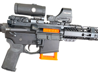 Bright orange Hugo Industries Safety Mag chamber flag with the text CLEAR on it inside an AR-15.