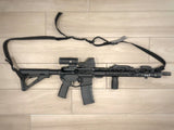 side profile of ar-15 rifle on tile with holosun 510c optic with cover on it